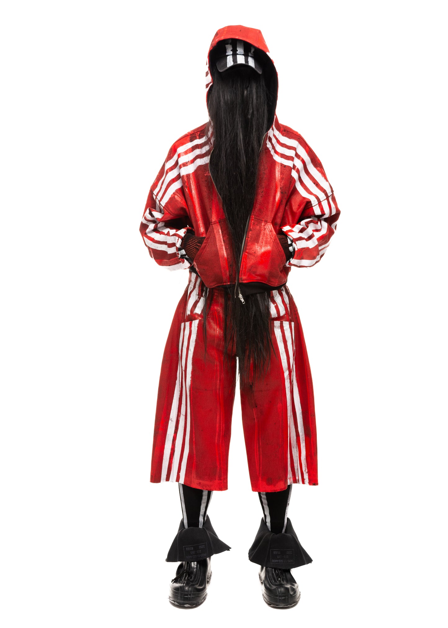 Model wearing red waxed denim shorts with white vertical stripes, front view.