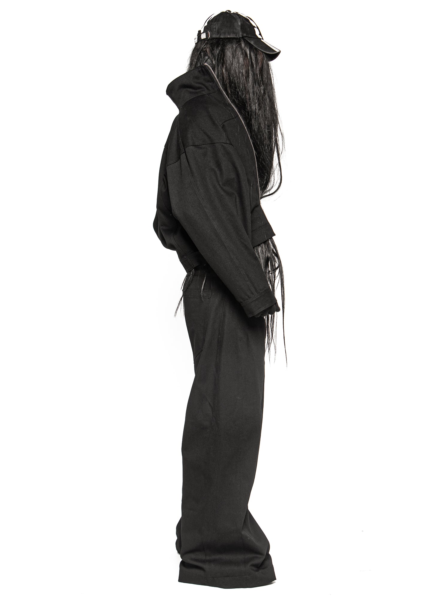 Side view of model wearing black cropped denim jacket with high collar