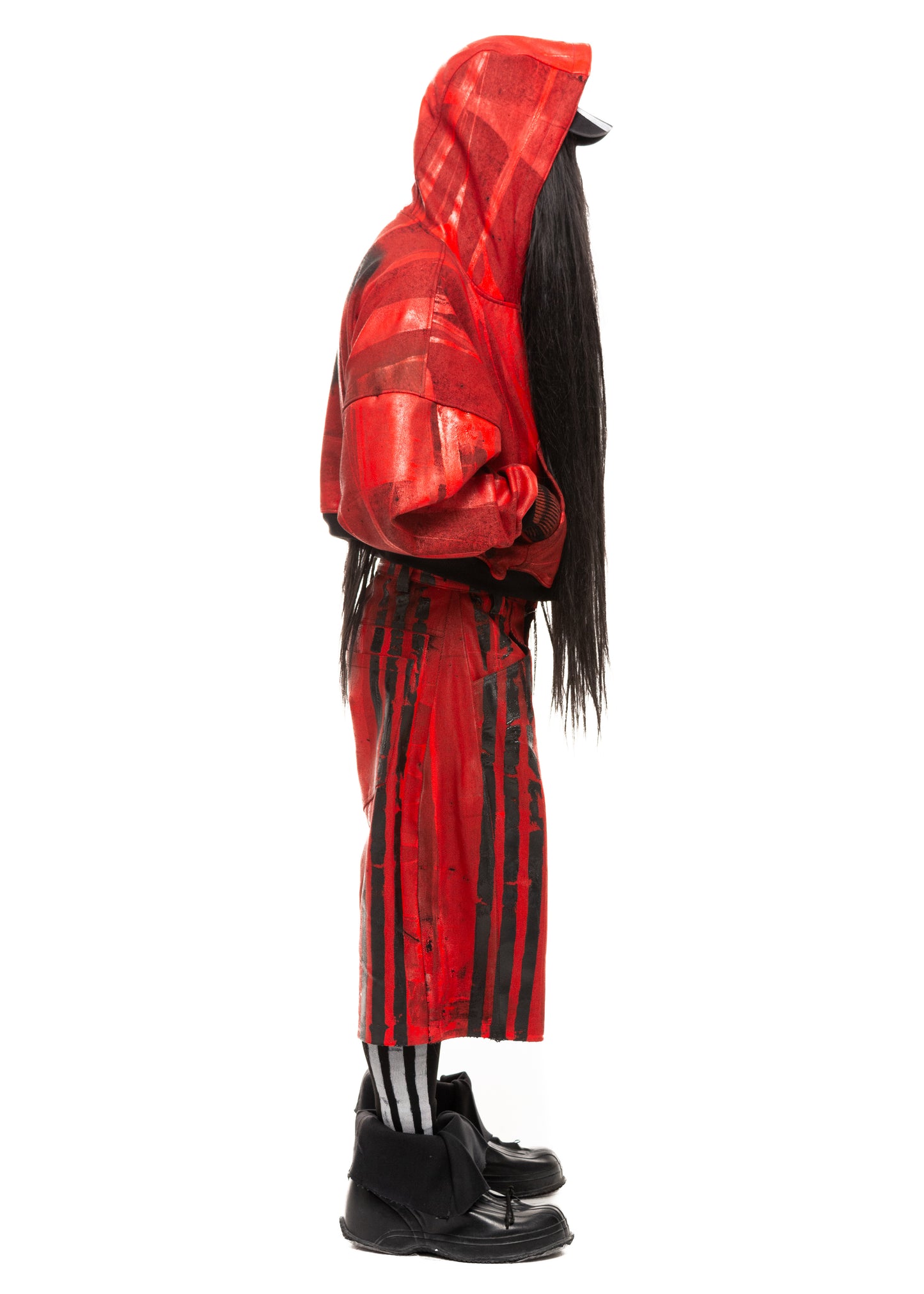 Waxed red denim shorts with printed black stripes, side view