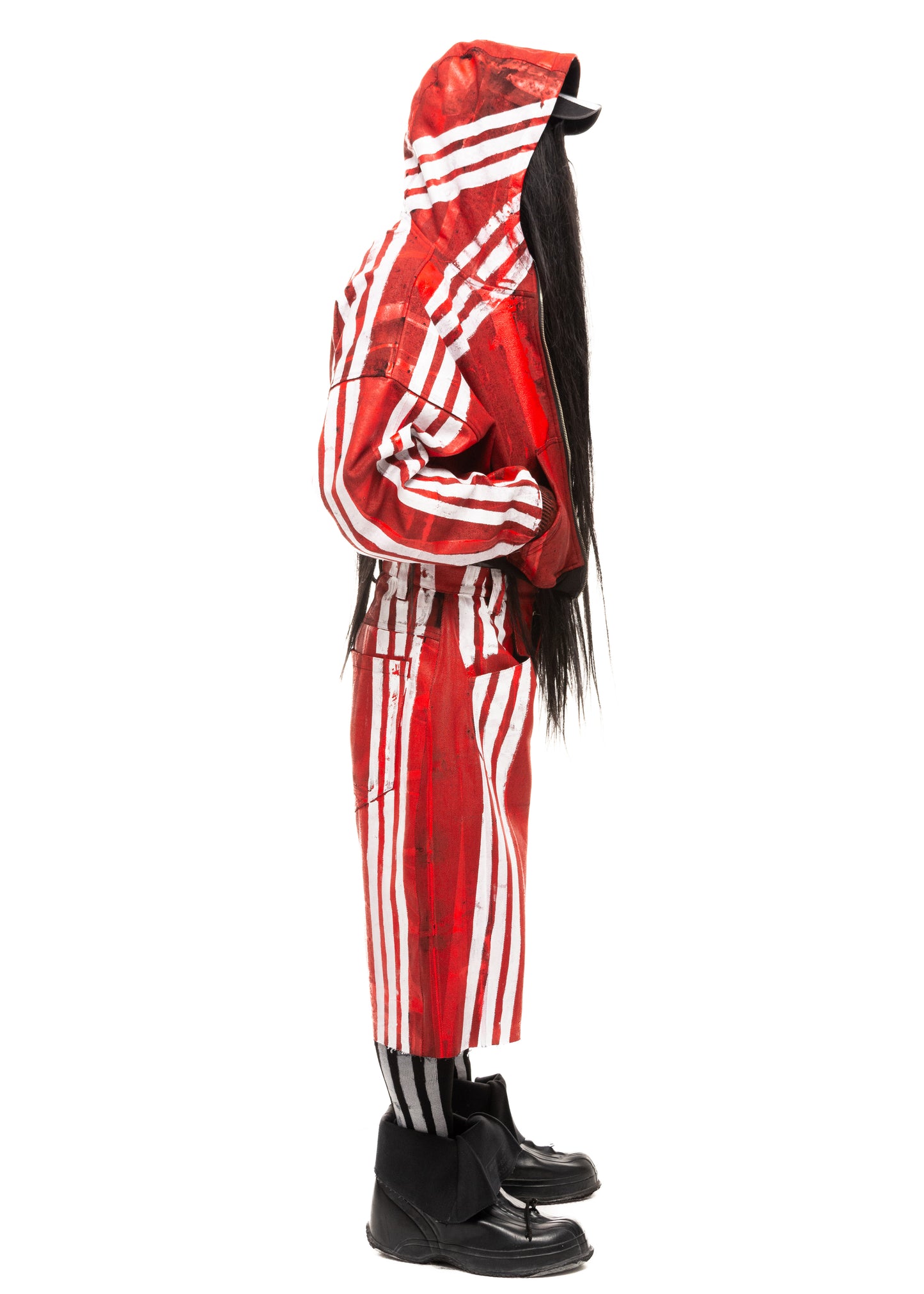 Model in red shorts with white stripes, profile view.