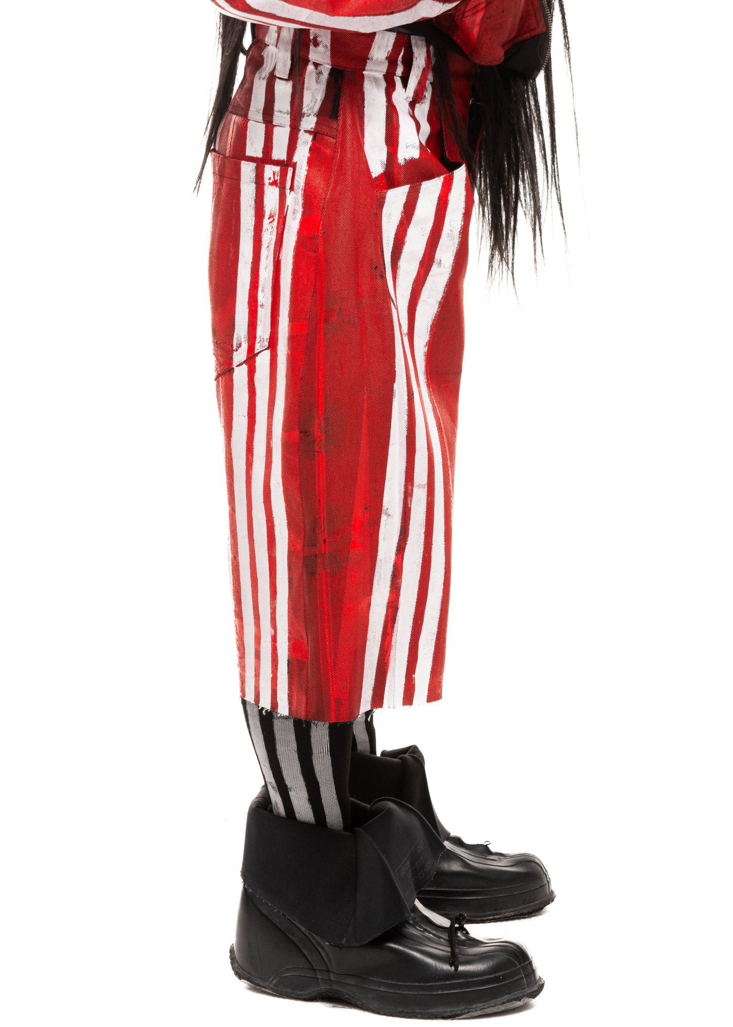 Side detail showing fabric texture and stripe print on red denim shorts.