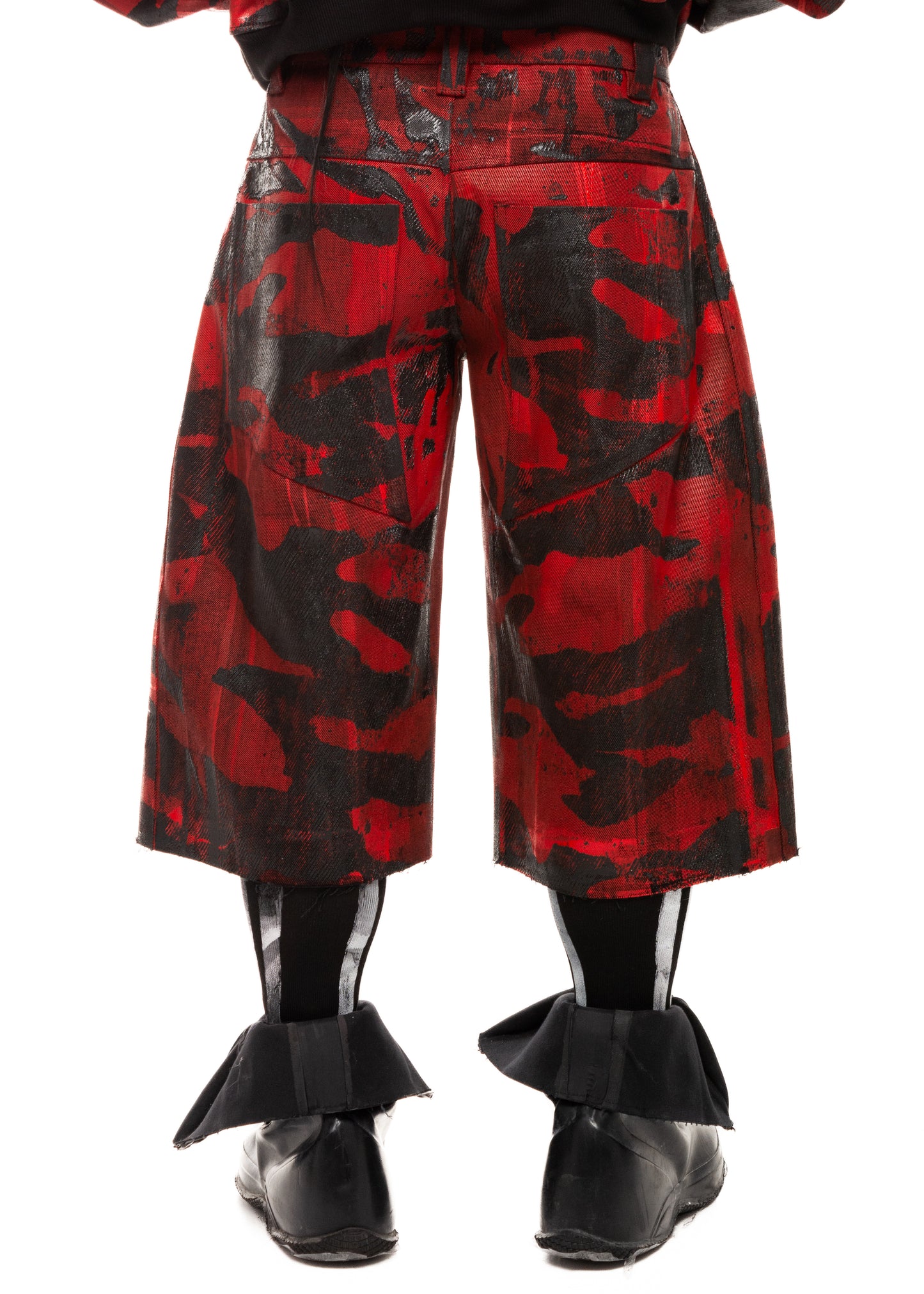 Close-up back detail of waxed camo denim shorts with structural seams