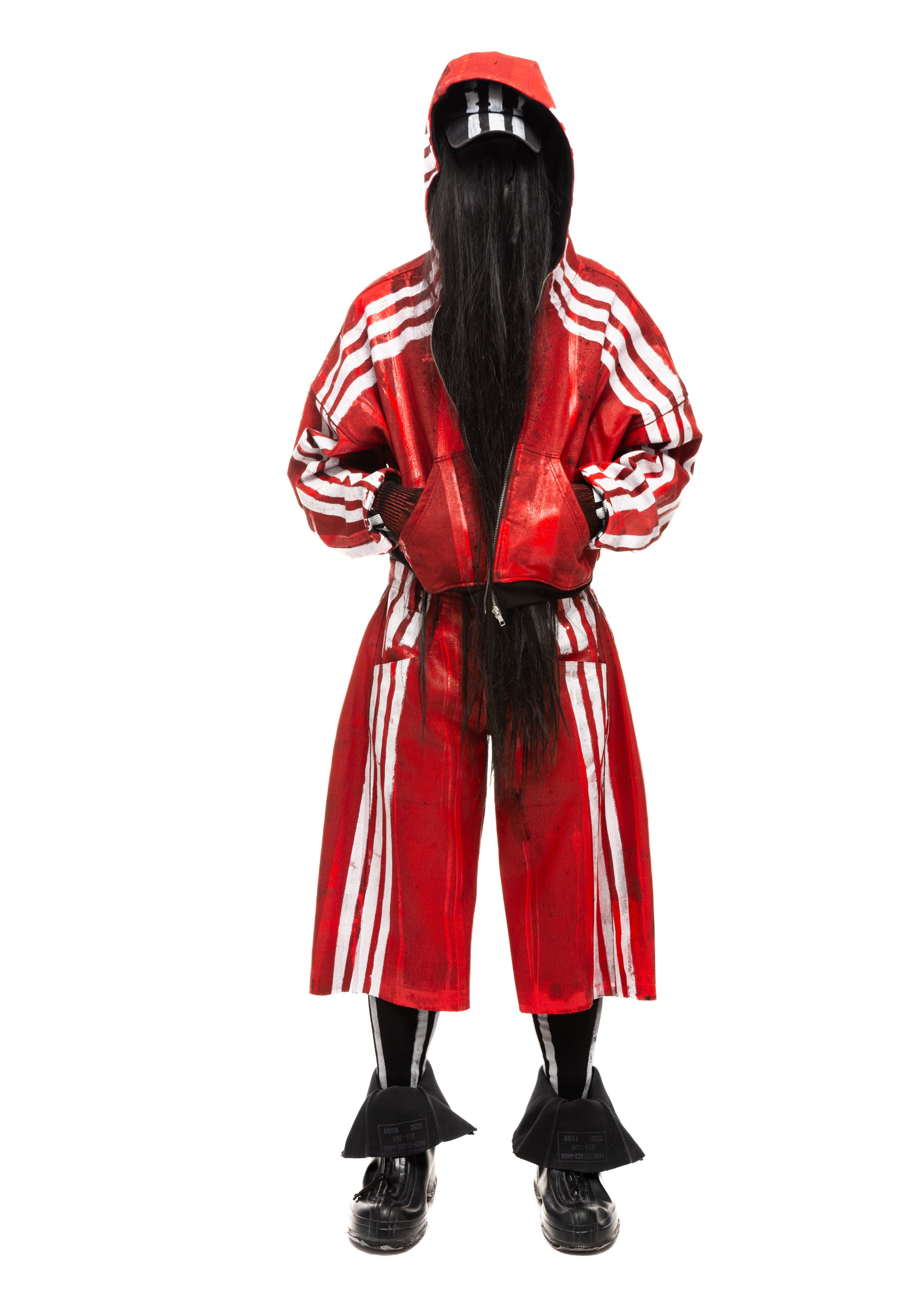 Model wearing red waxed denim shorts with white vertical stripes, front view.