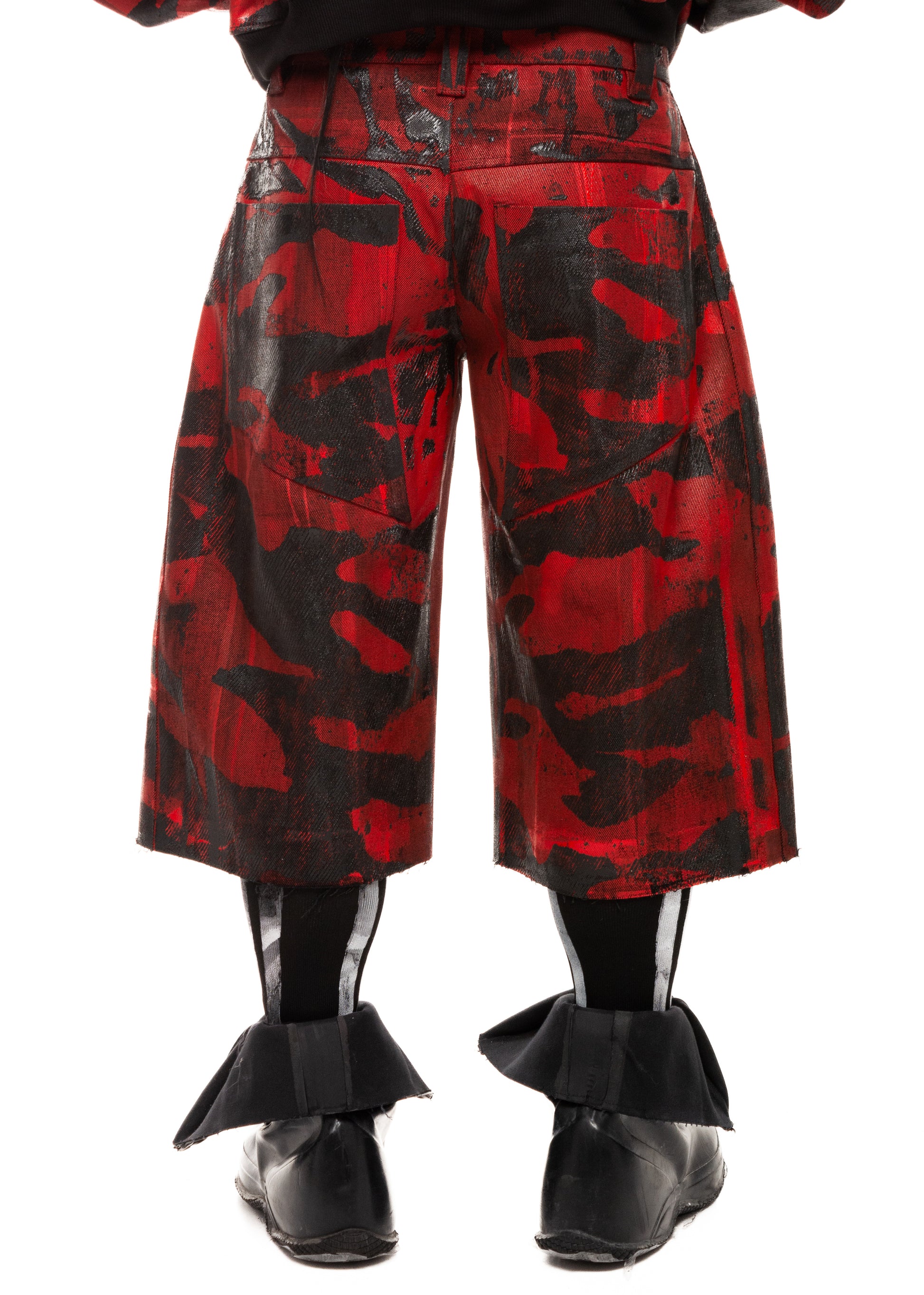 Close-up back detail of waxed camo denim shorts with structural seams